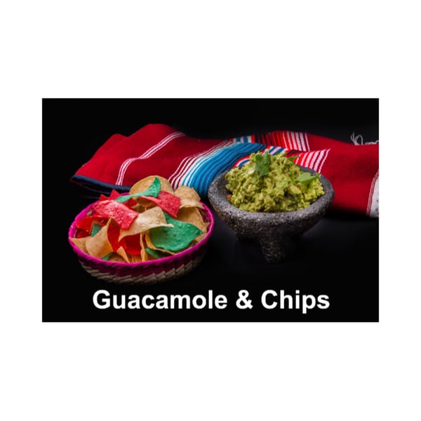 A molcajete of guacamole and a basket of colorful tortilla chips on a striped serape.