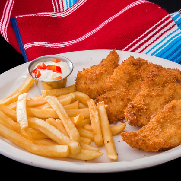 Crispy fried chicken tenders with golden french fries and a side of creamy dipping sauce.