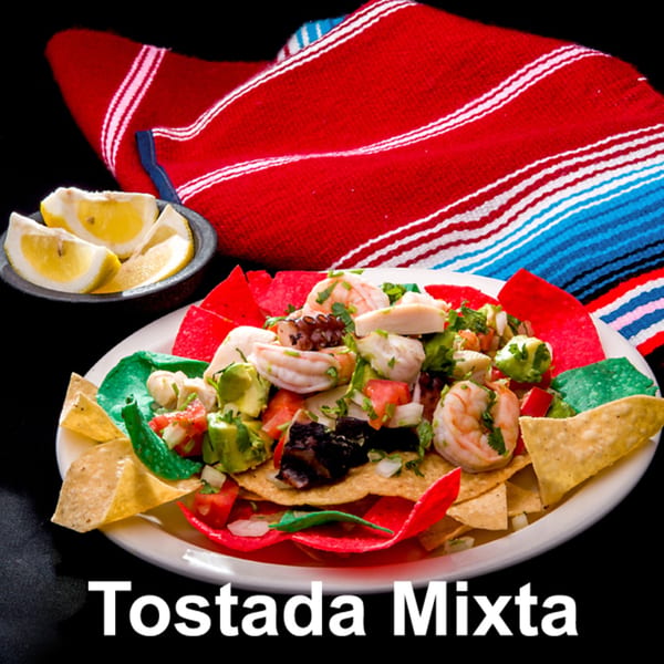 Las Tres Casuelas' Tostada Mixta with shrimp, octopus, avocado, and pico de gallo on colorful chips.