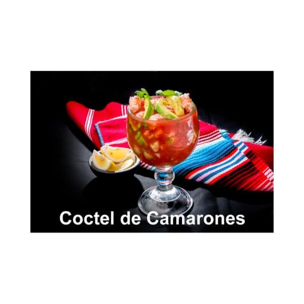 Coctel de Camarones, a shrimp cocktail with avocado and lime, on a colorful striped napkin.