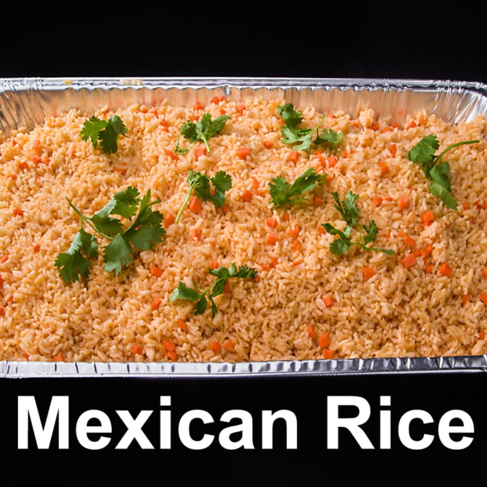 A catering tray filled with Las Tres Casuelas' Mexican rice, garnished with cilantro and carrots.